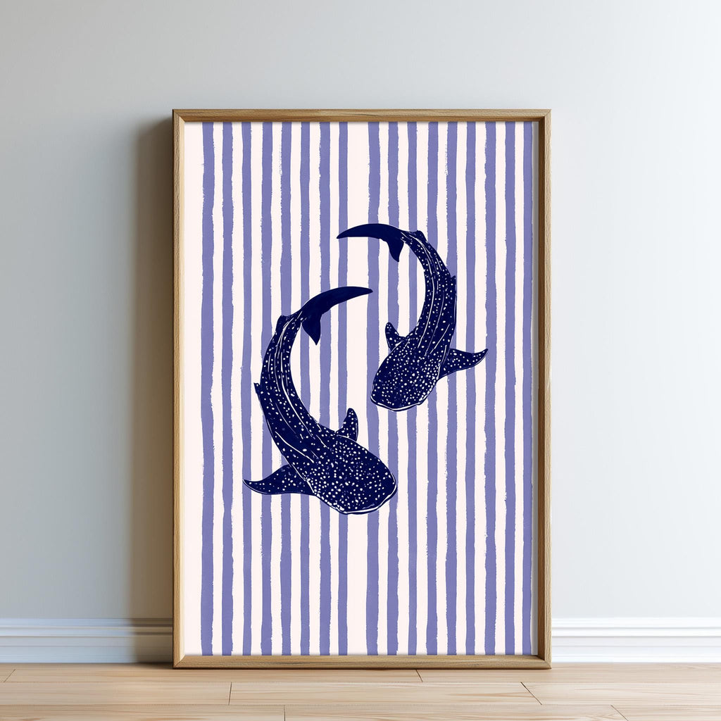 a framed artwork depicting two blue sharks swimming against a striped background.