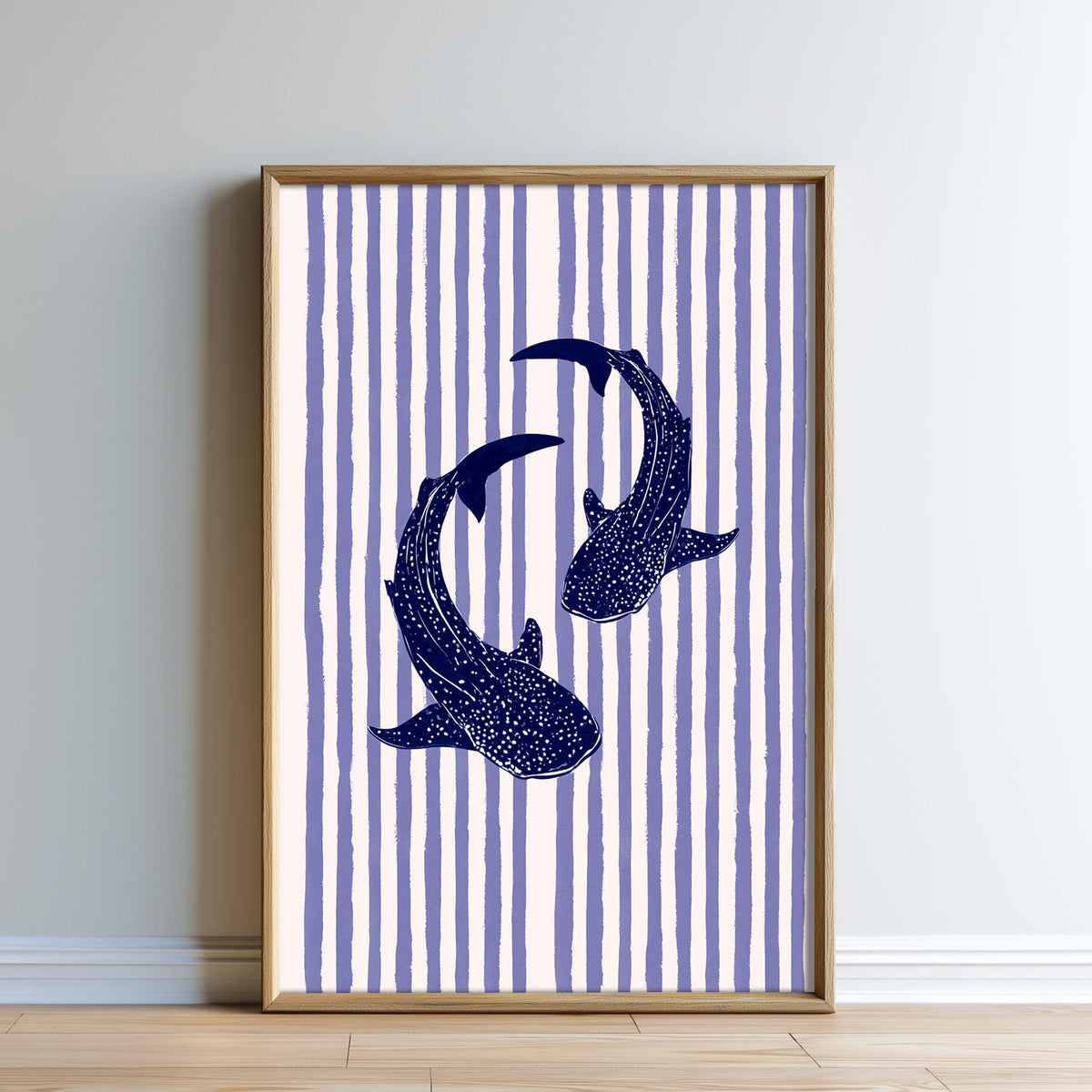 a framed artwork depicting two blue sharks swimming against a striped background.