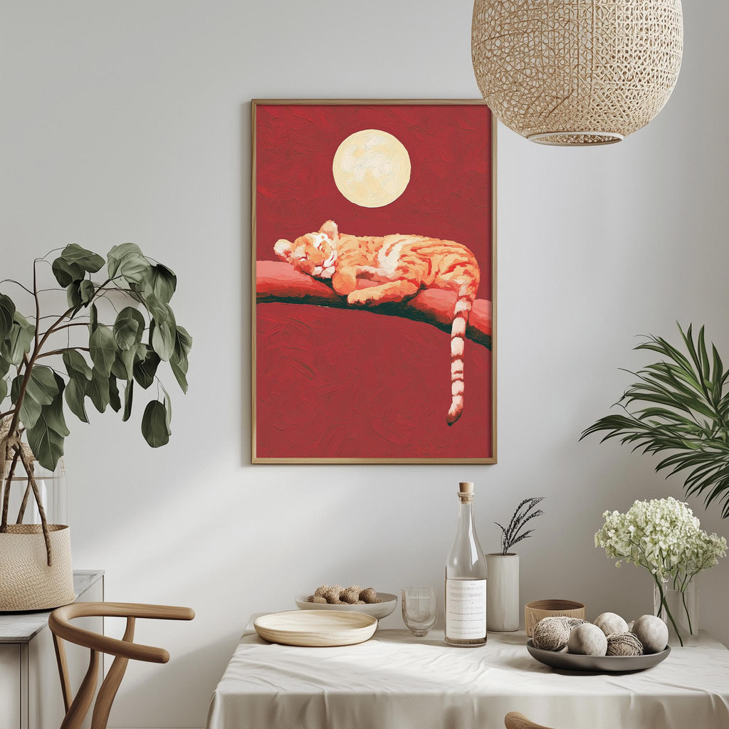 a dining table with a white tablecloth, a bowl of fruit, a bottle, and a vase with flowers. Above the table, there is a framed painting of a tiger resting on a branch, with a large moon in the background.