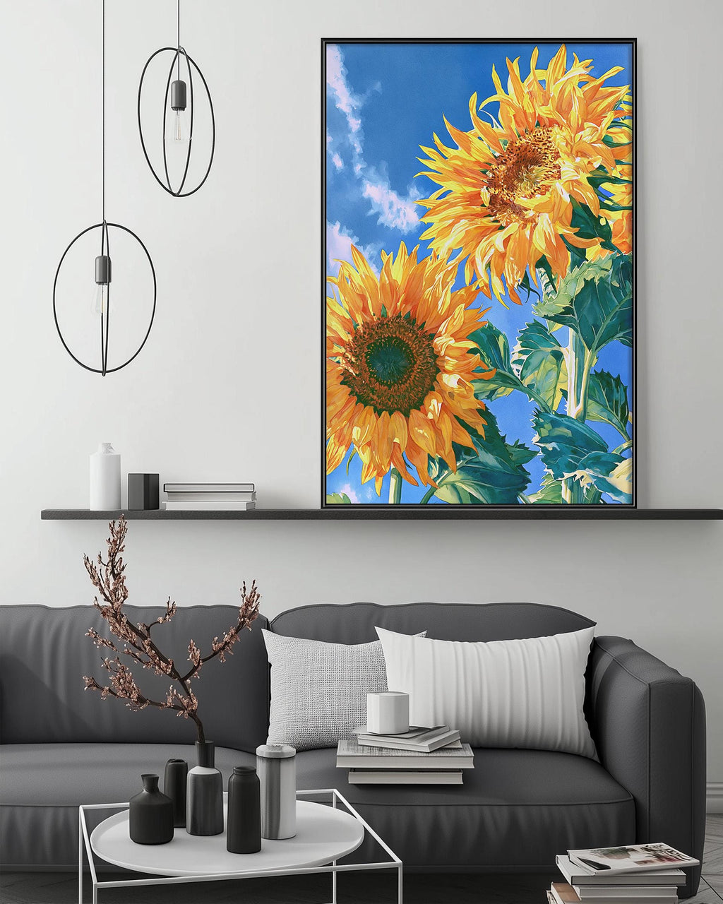 a large framed painting of two vibrant sunflowers on a wall above a gray couch in a living room setting.