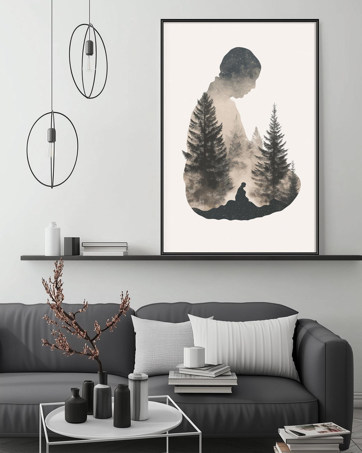 a modern living room with a gray sofa, a coffee table, and a large framed artwork depicting a silhouette of a person sitting in a forest setting.