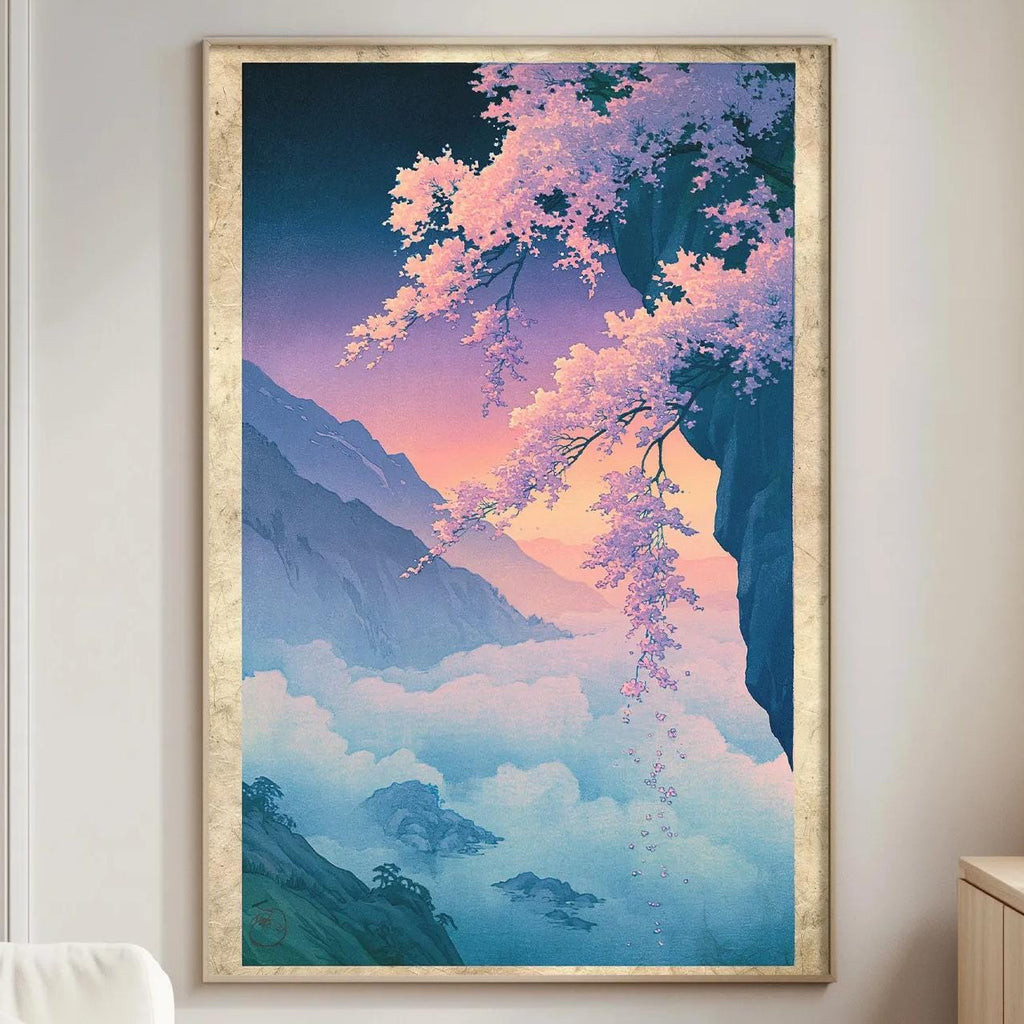 a large framed painting of a serene landscape with mountains, trees, and a colorful sky, hanging on a wall in a living room.