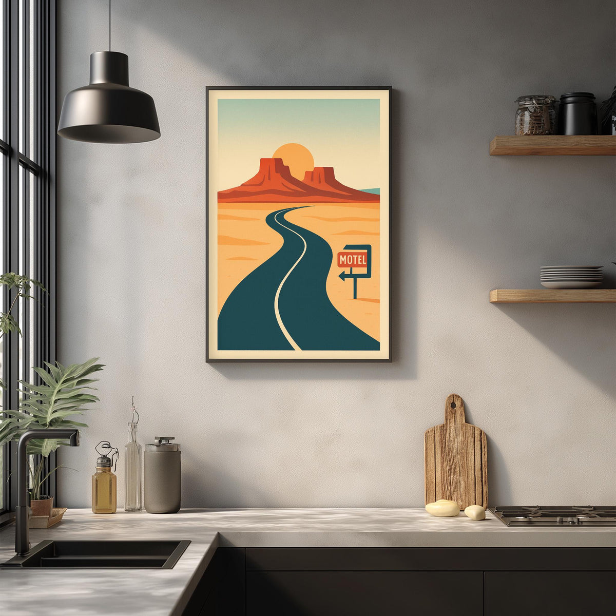 a framed poster of a desert road with a motel sign, hanging on a wall above a kitchen counter with various kitchen items and a potted plant.