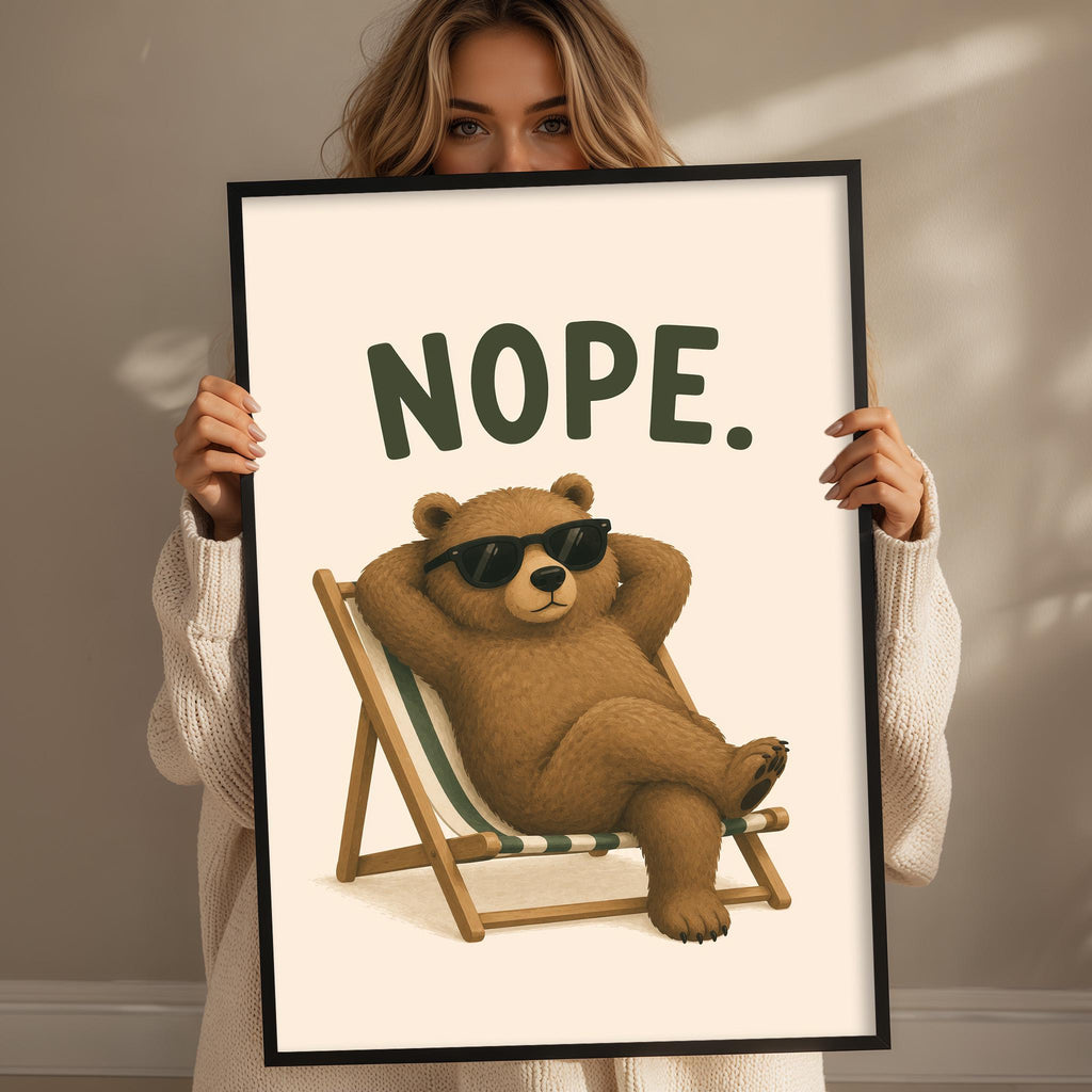A woman is holding up a framed poster with a cartoon image of a bear wearing sunglasses and reclining in a chair.