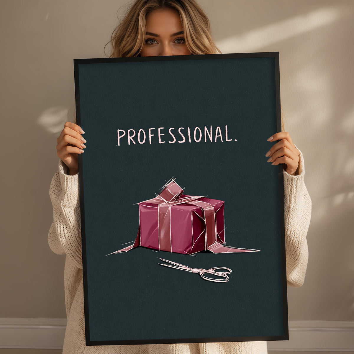 A woman holding a framed poster with a graphic of a gift box and scissors.