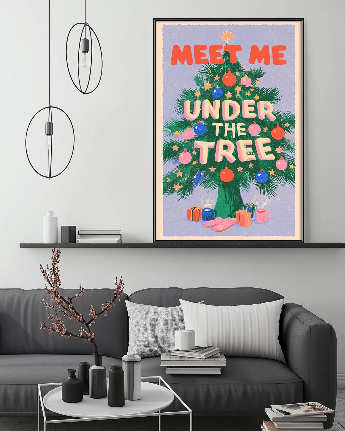 a large framed poster with the text "MEET ME UNDER THE TREE" on it, hanging on a wall above a gray couch in a living room setting.