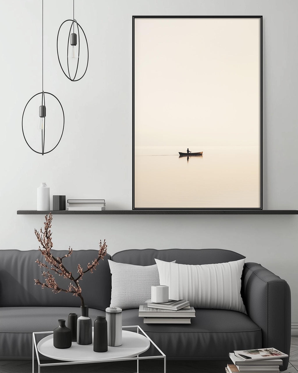 a serene living room with a gray sofa, a coffee table, and a large framed picture of a boat on the wall. The room has a minimalist and modern design, with a black and white color scheme and a few decorative elements such as a potted plant and a vase.