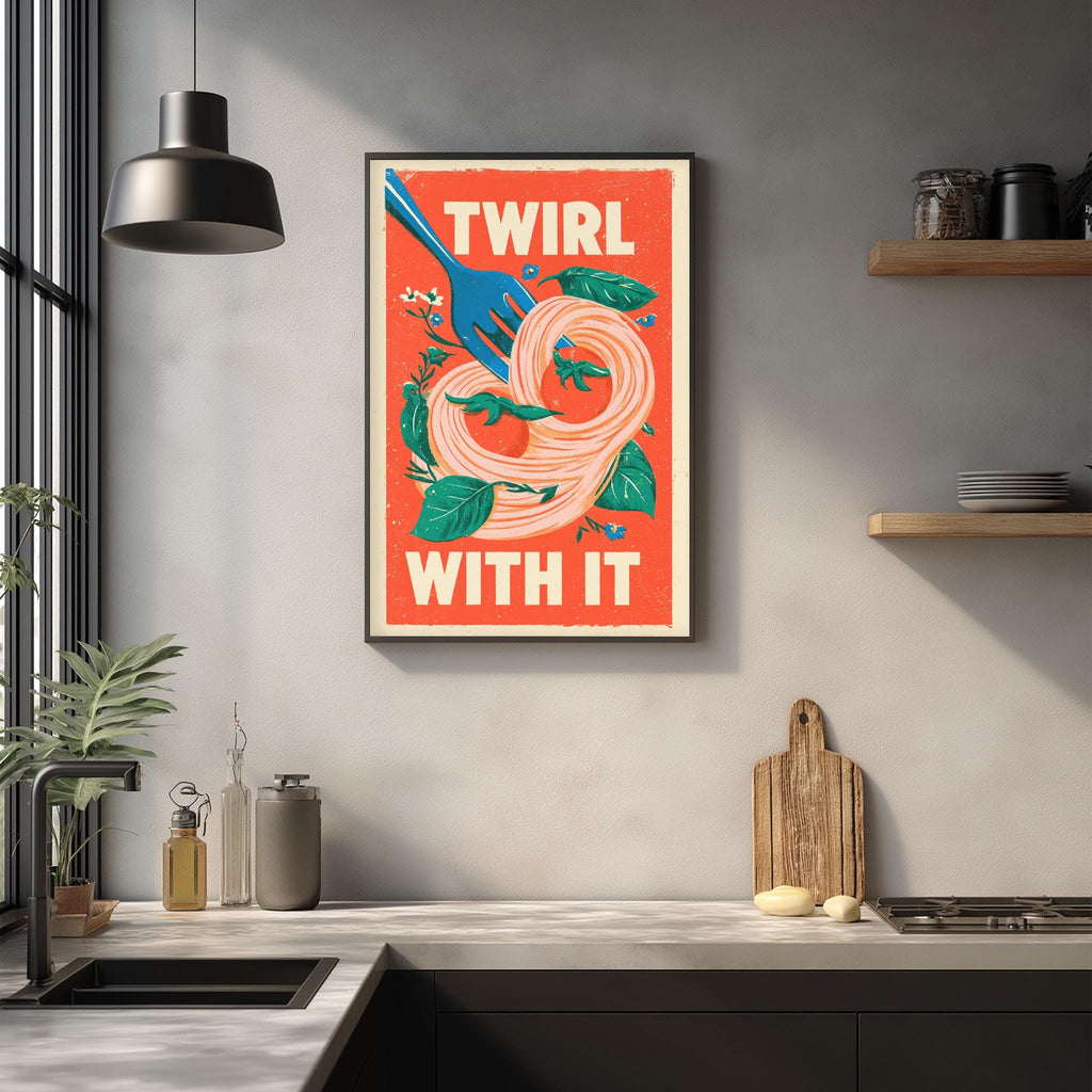 a kitchen counter with a framed poster hanging on the wall above it. The poster has a vibrant design with a fork and noodles, and the text "TWIRL WITH IT" is prominently displayed.