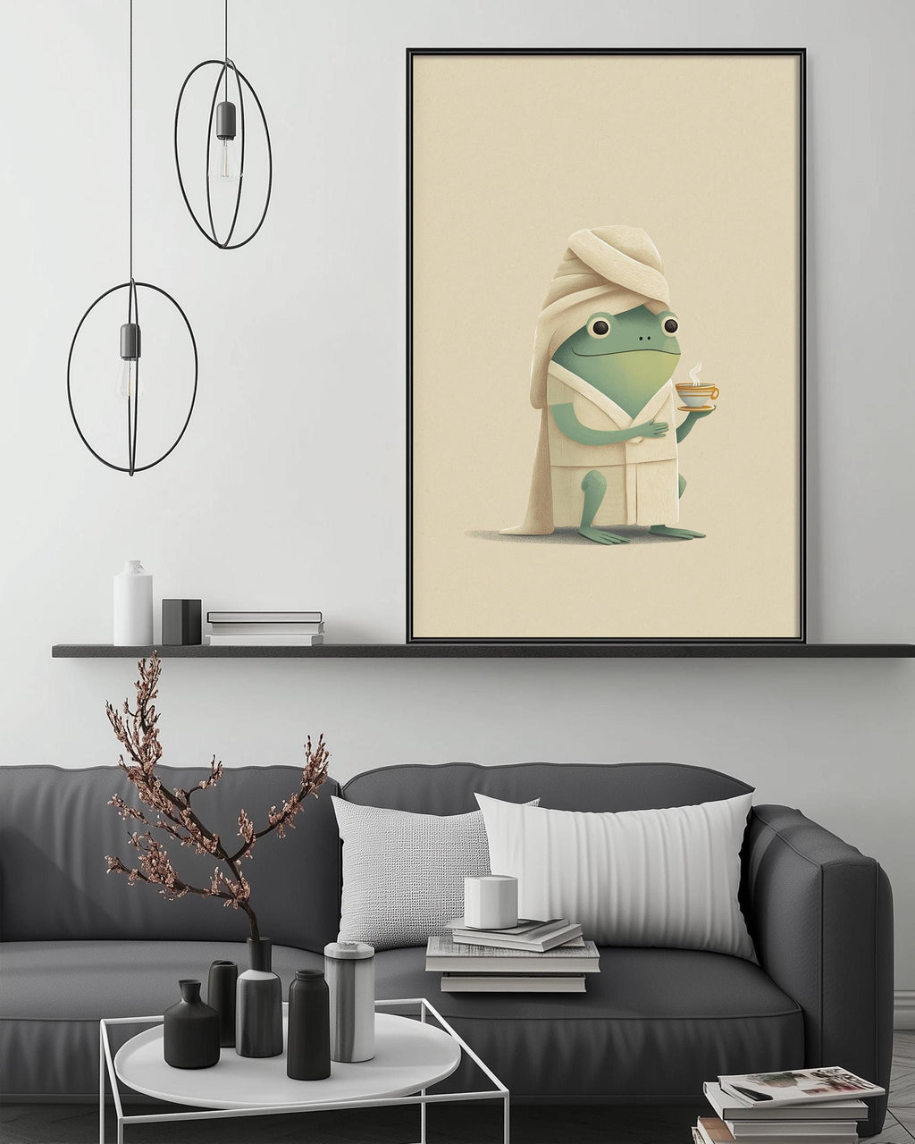 a cozy living room with a gray couch, a coffee table, and a framed illustration of a frog wearing a bathrobe and holding a cup of tea.