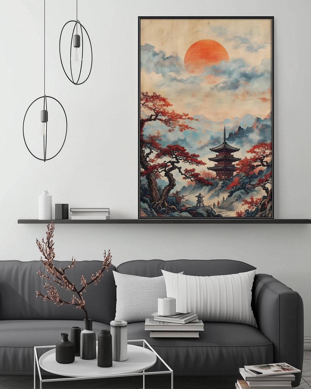 a living room with a gray sofa, a coffee table, and a large framed painting of a Japanese temple with a red sun in the sky. The painting is hanging on the wall above the sofa.