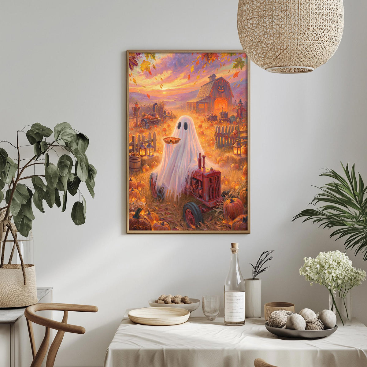 a Halloween-themed painting of a ghost standing in a field with a tractor, pumpkins, and a barn in the background. The painting is hung on a wall above a table with various items on it, including a bottle, a vase, and a bowl.