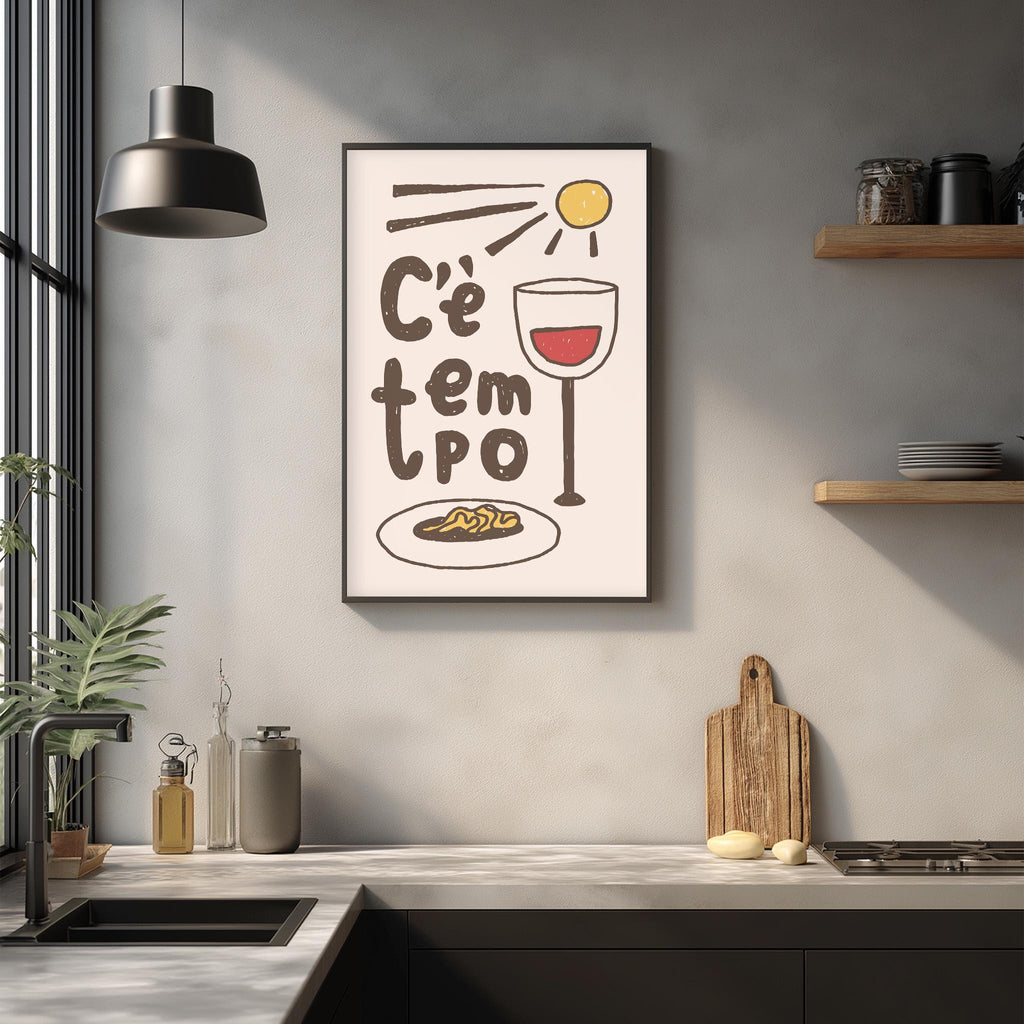 a kitchen counter with various kitchen items, including a framed poster with a wine glass and a plate of food, a potted plant, and a cutting board.