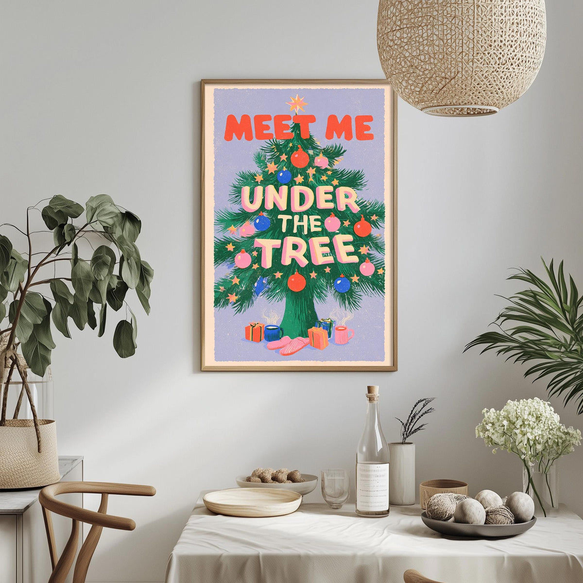 a framed poster with the text "MEET ME UNDER THE TREE" hanging on a wall above a dining table with various items on it.
