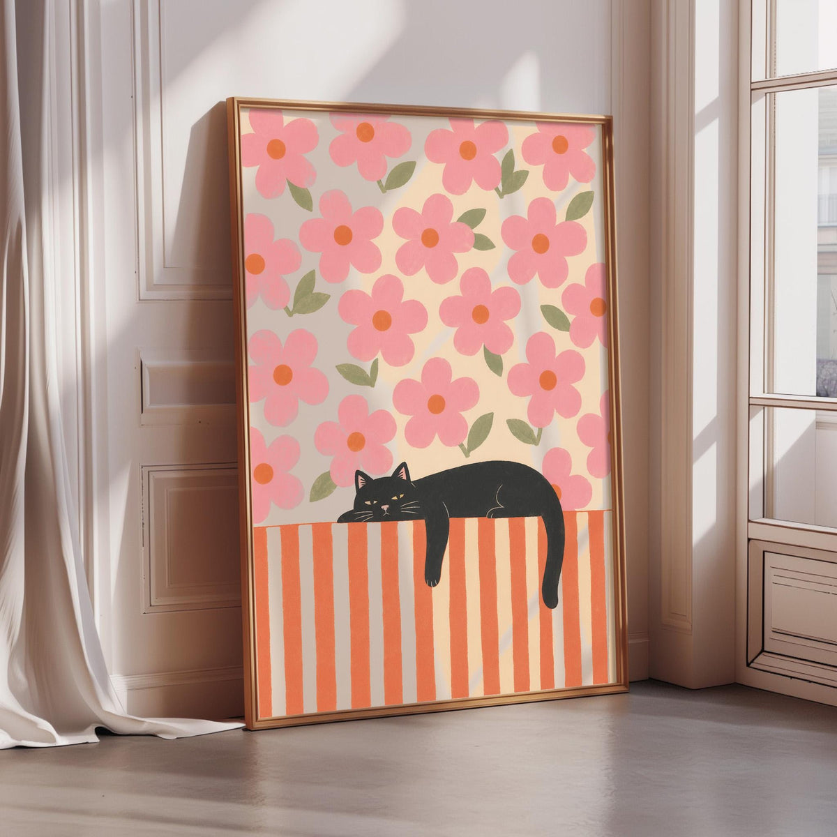A framed poster featuring a black cat lying on a striped surface, with a background of pink flowers.