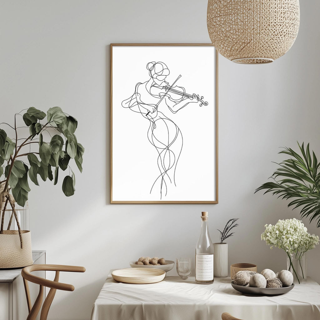 a minimalist dining room with a framed drawing of a woman playing a violin hanging on the wall. The dining table is set with various items, including a bottle, a bowl, and a vase with flowers. The room is decorated with potted plants and a woven light fixture, creating a serene and elegant atmosphere.