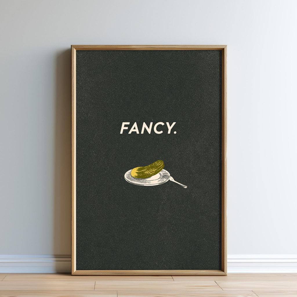 The image is a framed poster with a black background and a white text that says "FANCY."