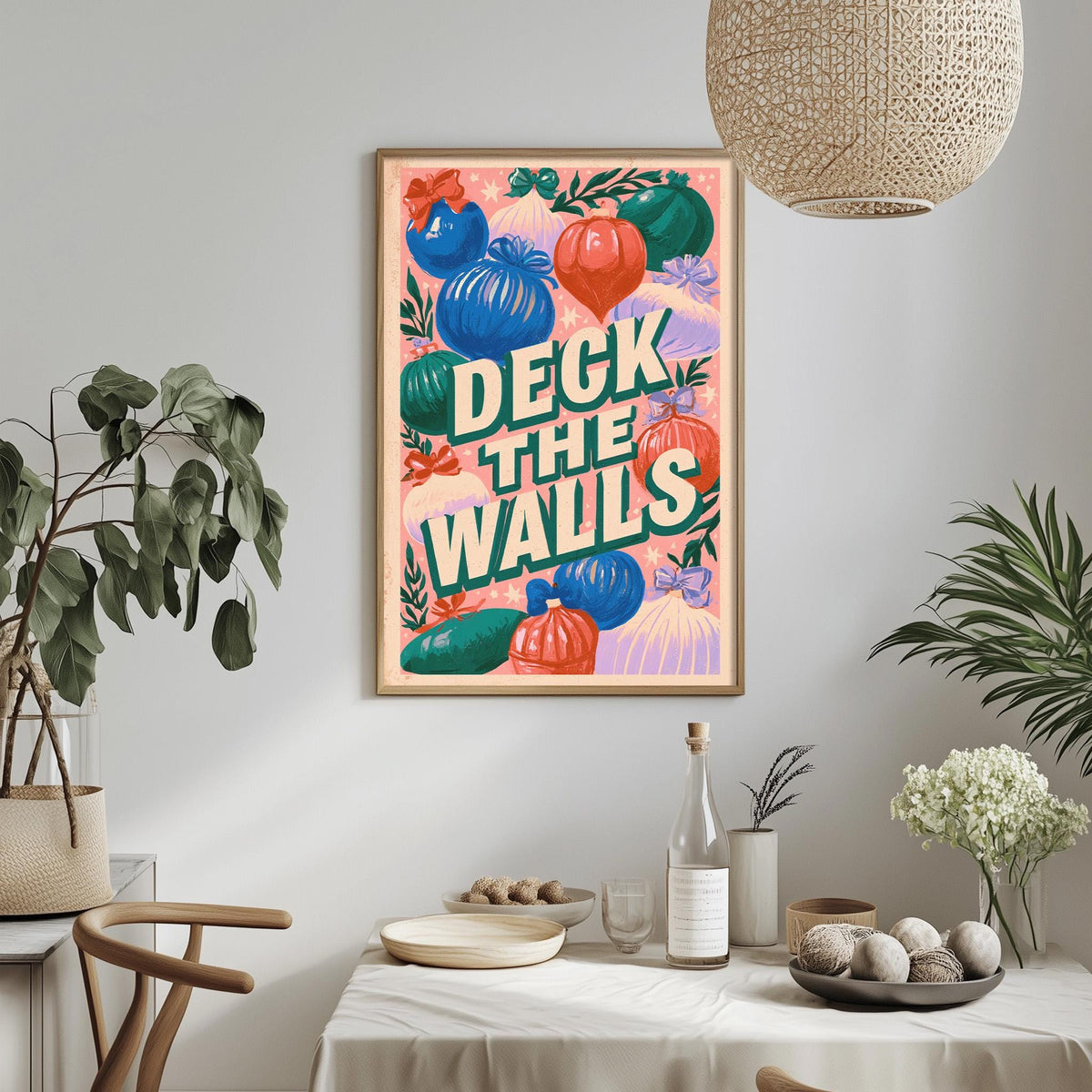 a framed poster with a colorful design hanging on a wall above a dining table with various decorative items and plants.