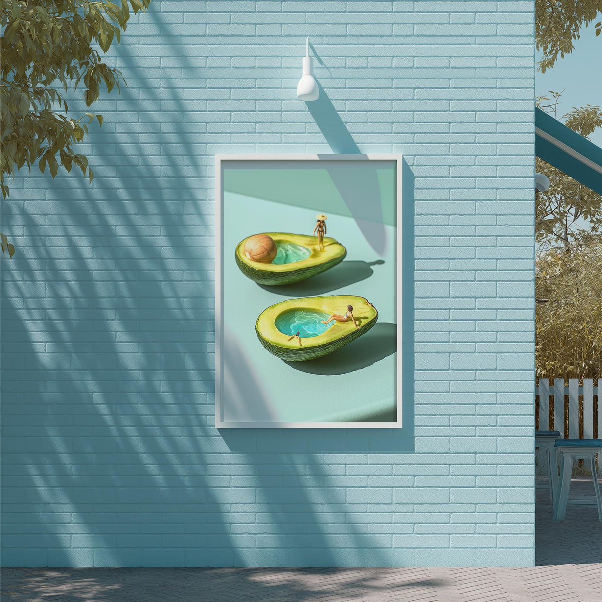 a framed artwork depicting two halves of an avocado, with one half submerged in water and the other half floating on the surface.