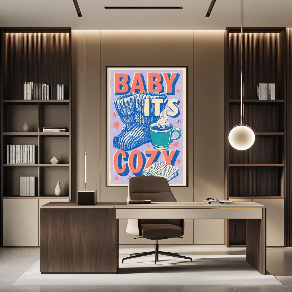 a modern office space with a large framed poster on the wall that reads "BABY IT'S COZY". The poster has a blue and orange design with a cup of coffee and a cozy blanket. The office has a wooden desk, a chair, and a bookshelf filled with books. The overall design of the space is contemporary and inviting.