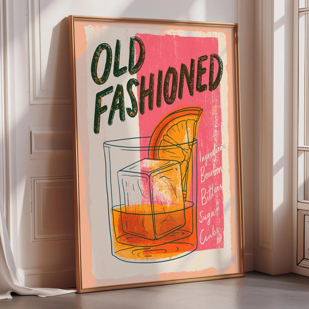 a framed poster advertising "Old Fashioned" cocktails, with a colorful illustration of a cocktail glass and a slice of orange.