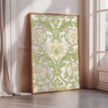 A large framed print with a floral pattern in shades of green and white is displayed on a wall in a room with a window.