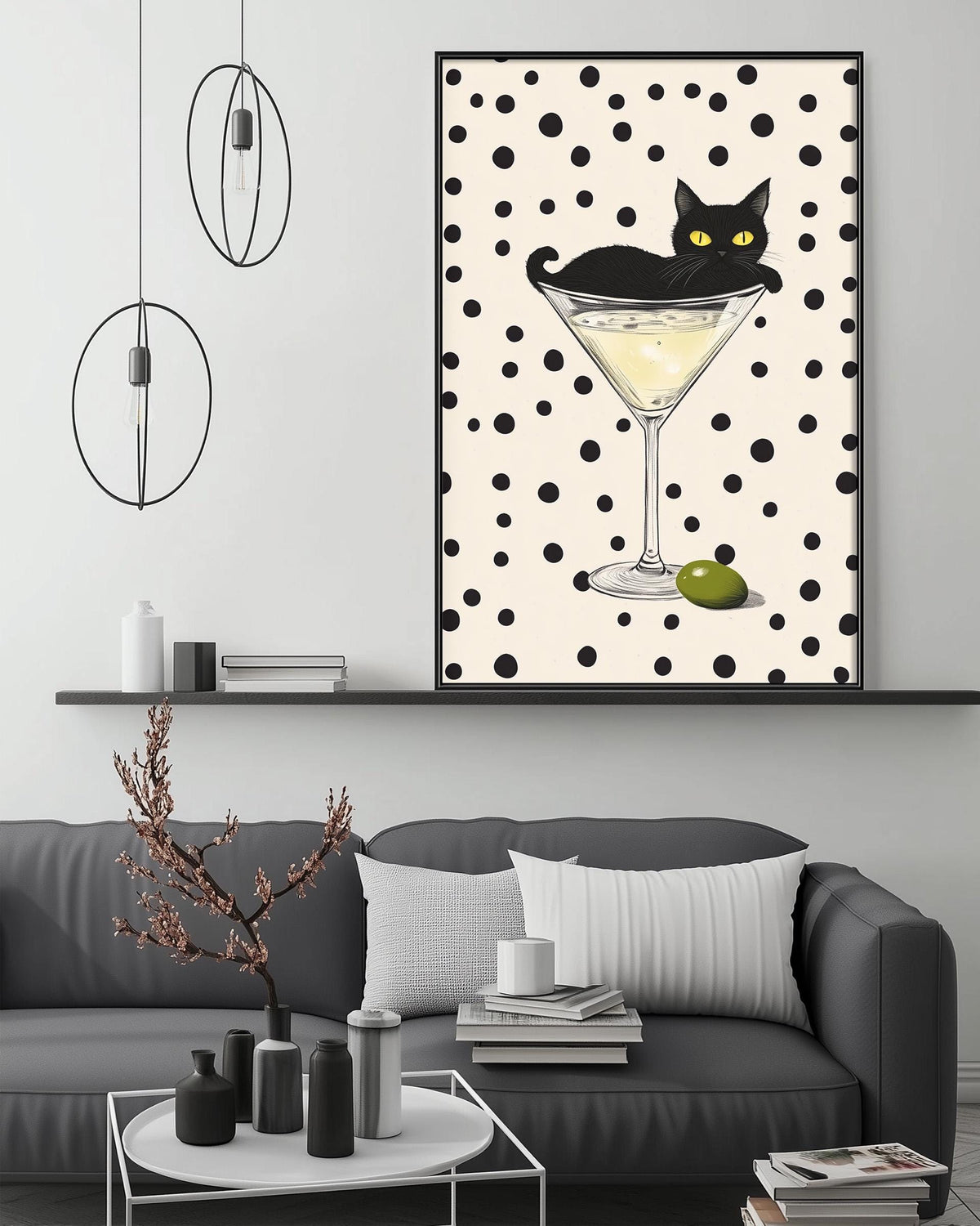 a black cat sitting in a martini glass, surrounded by a green olive, on a white wall.