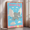A framed poster with a cartoon elephant flying through the sky with wings, accompanied by the text "dream big".