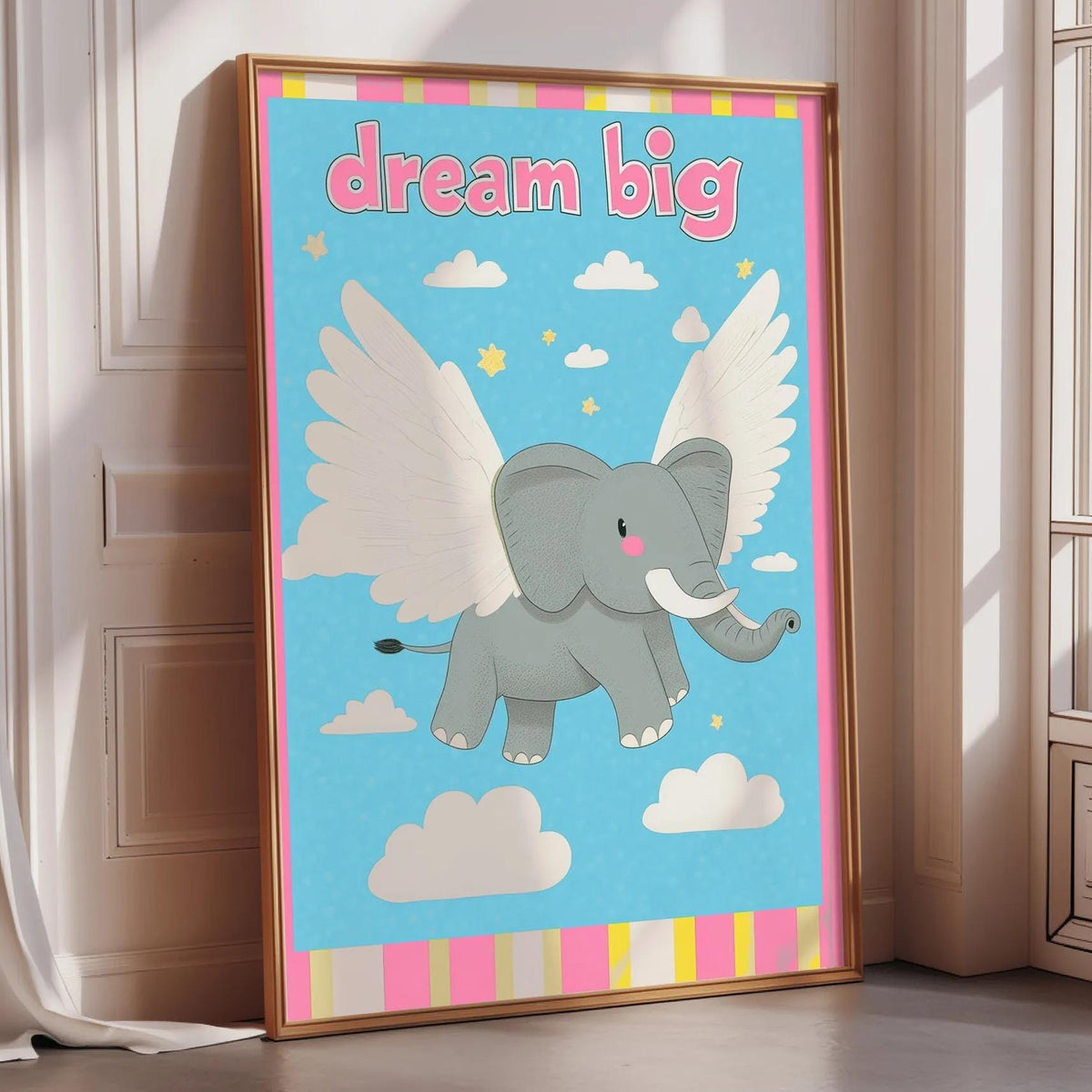 A framed poster with a cartoon elephant flying through the sky with wings, accompanied by the text "dream big".