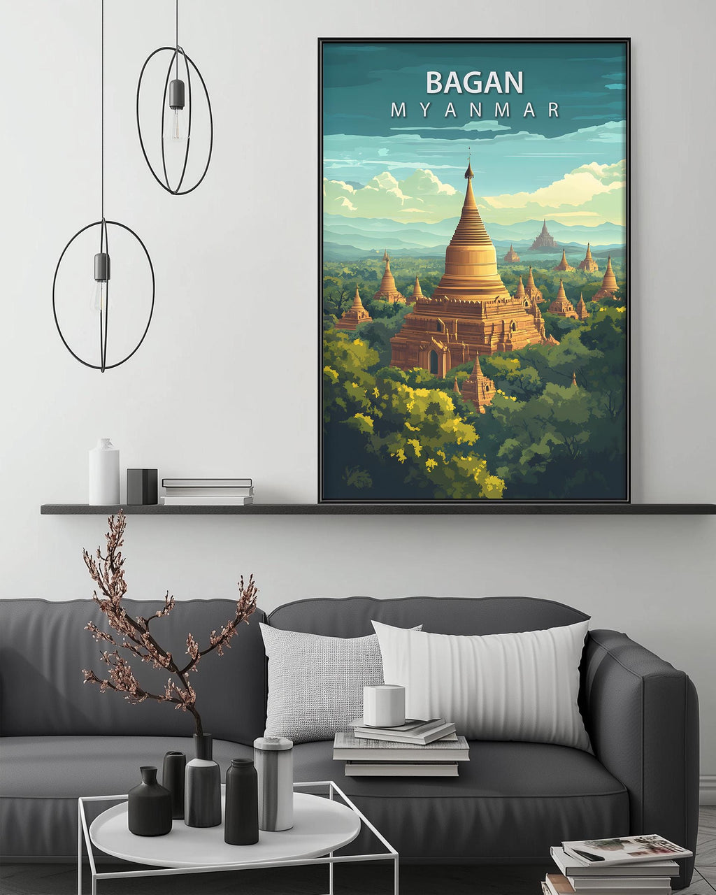 a large framed poster of the Bagan temple complex in Myanmar, hanging on a wall above a gray couch in a living room setting.