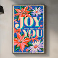 a kitchen counter with a framed poster of a colorful floral design hanging above it. The poster has the text "JOY YOU" written on it, and there are various kitchen items, such as a cutting board, bottles, and a sink, visible on the counter.