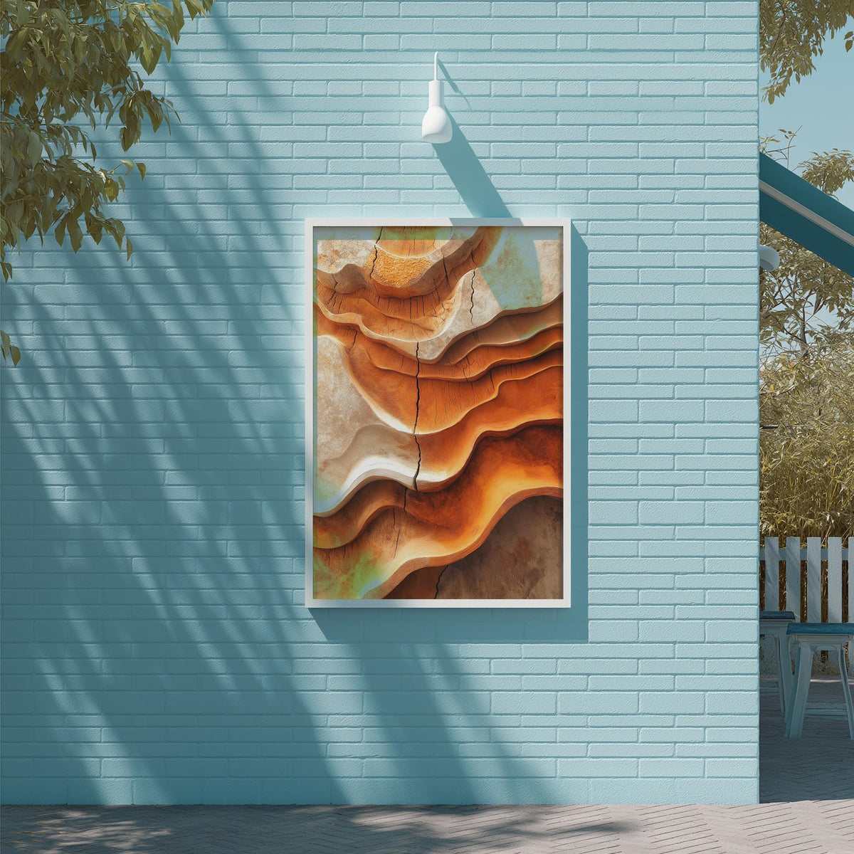 a large abstract painting hanging on a blue wall, with a white light fixture above it.