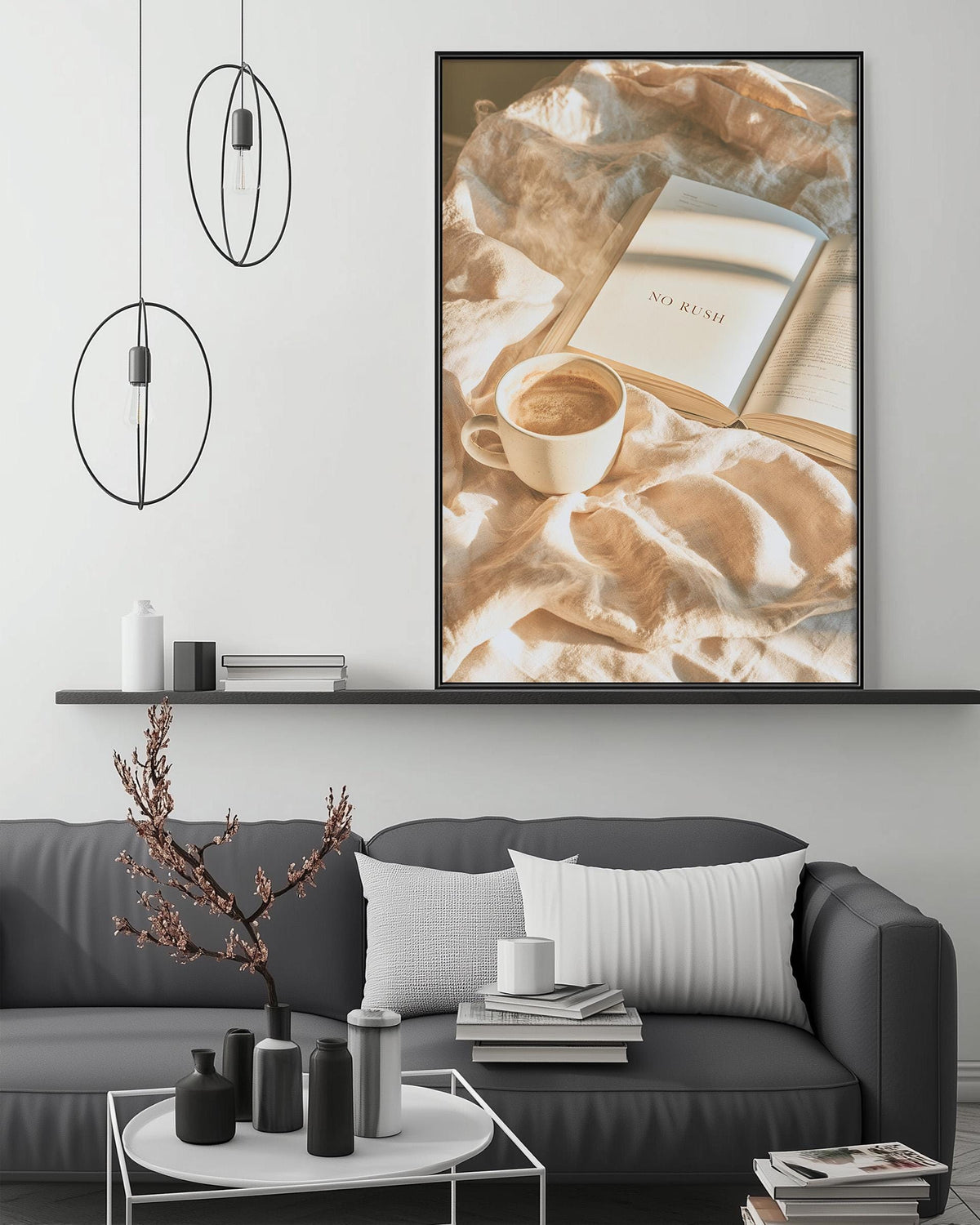 a cozy living room setting with a gray sofa, a coffee table, and a framed picture of a book and coffee on the wall.