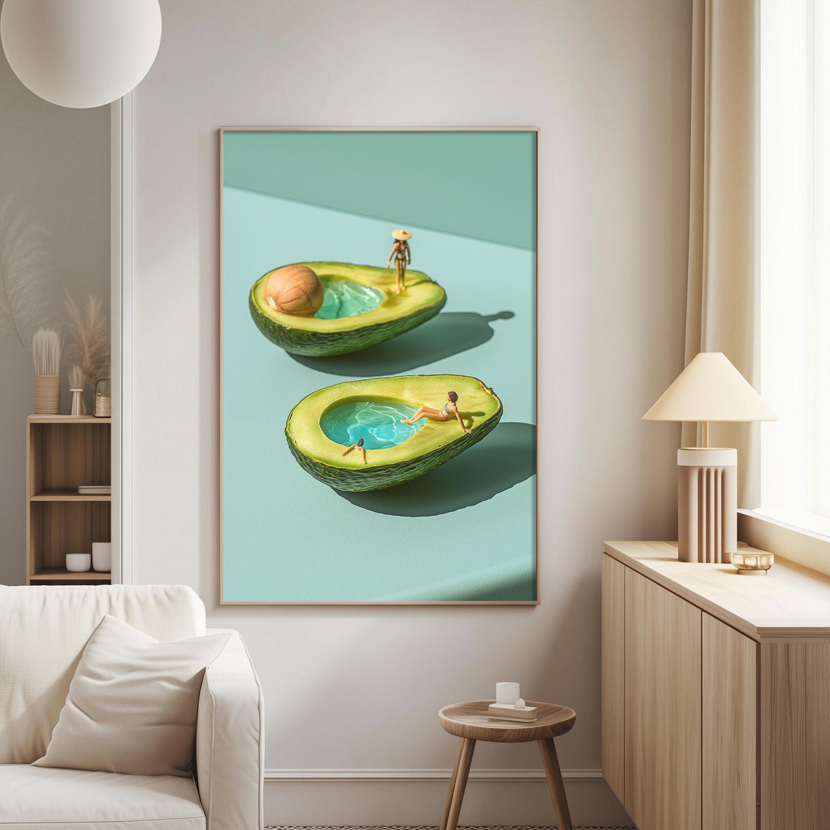 a large framed artwork depicting two avocados with miniature figures inside them, creating a whimsical and surreal scene.