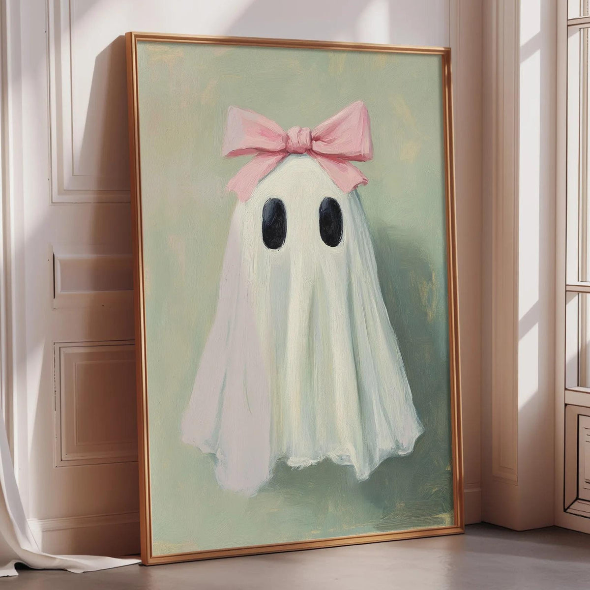 a painting of a ghost with a pink bow on its head, displayed on a wall in a room with a window.