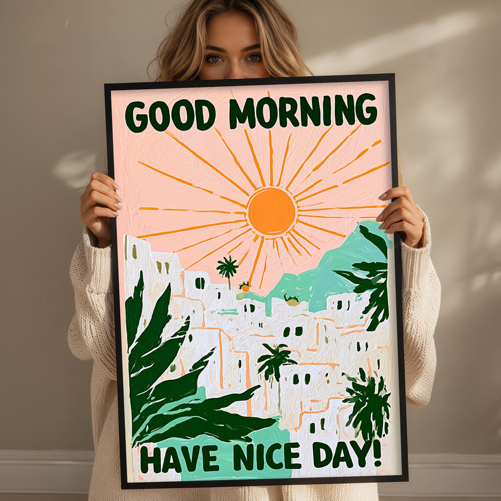 A woman holding a framed poster with a colorful illustration of a tropical landscape and the text "GOOD MORNING HAVE NICE DAY!"
