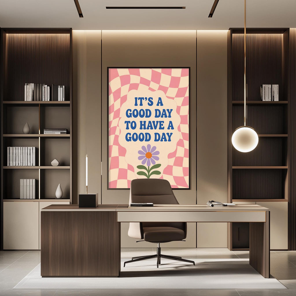 a modern office space with a large framed poster on the wall that reads "IT'S A GOOD DAY TO HAVE A GOOD DAY". The office has a wooden desk, a chair, and a bookshelf filled with books. The overall design and decor create a pleasant and inspiring atmosphere.