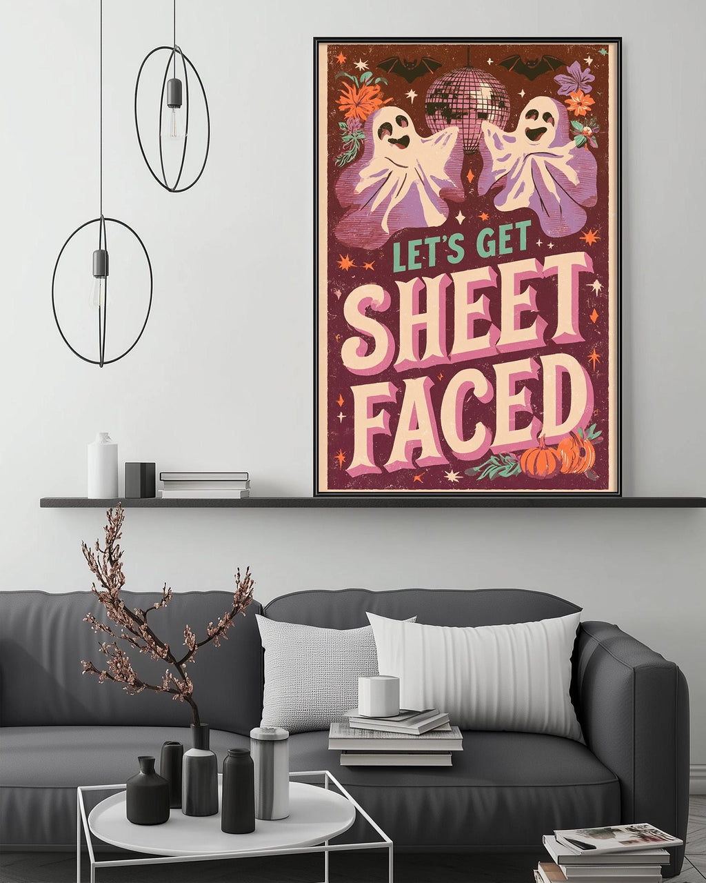 a poster with a Halloween theme, hanging on a wall above a gray couch with a coffee table in front of it.