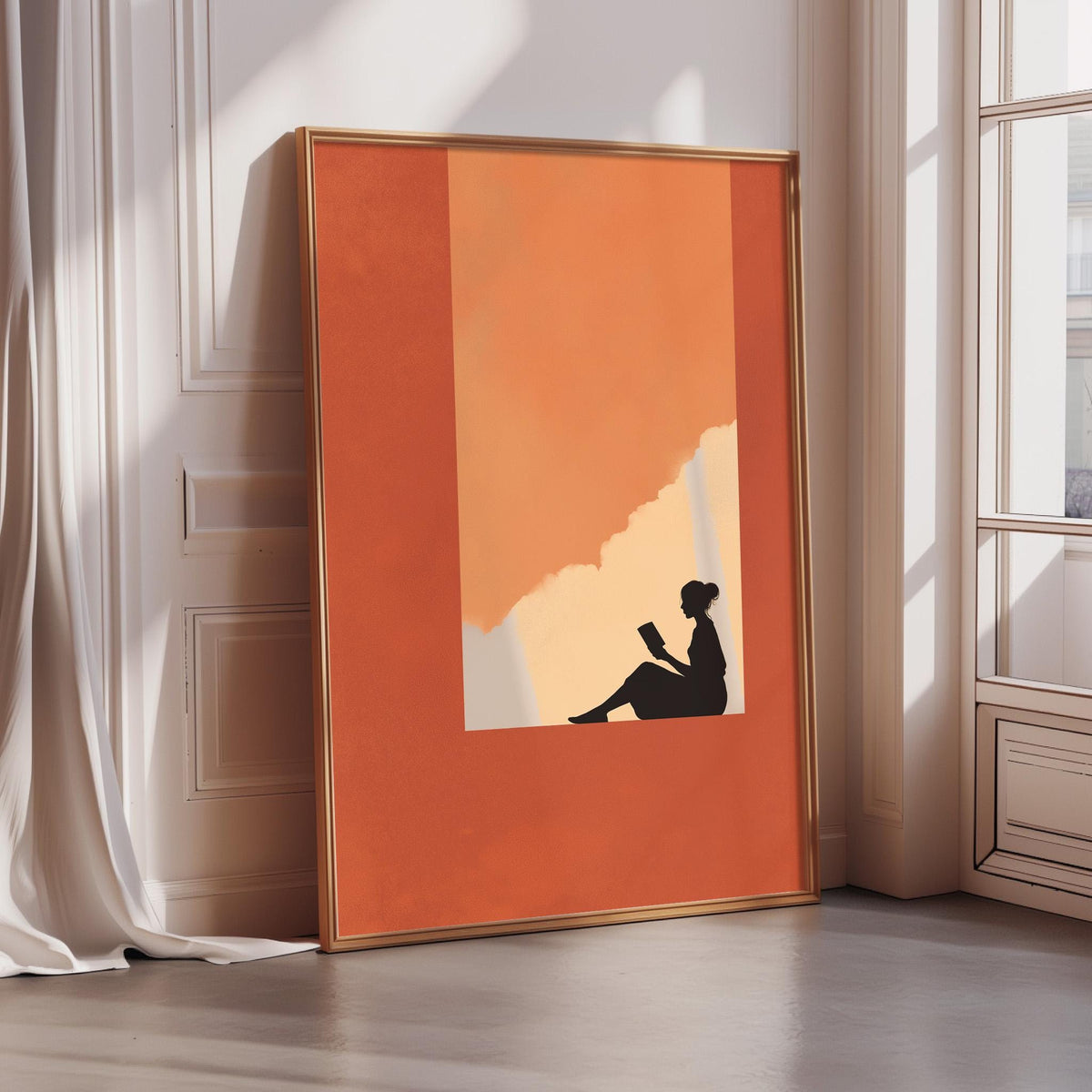 a large orange framed poster depicting a silhouette of a person sitting and reading a book.