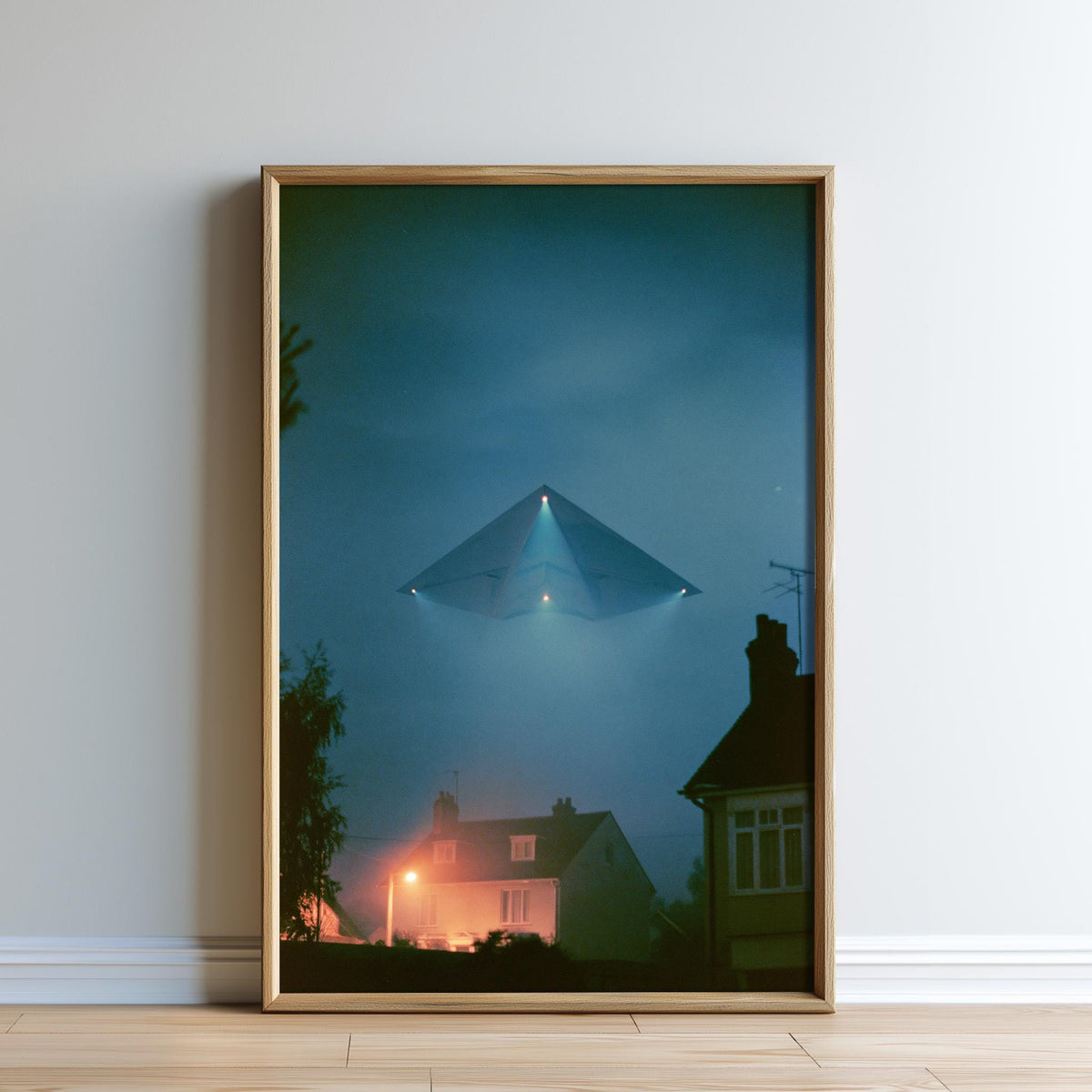 a large, triangular-shaped object hovering above a residential area at night, with houses and trees visible below.