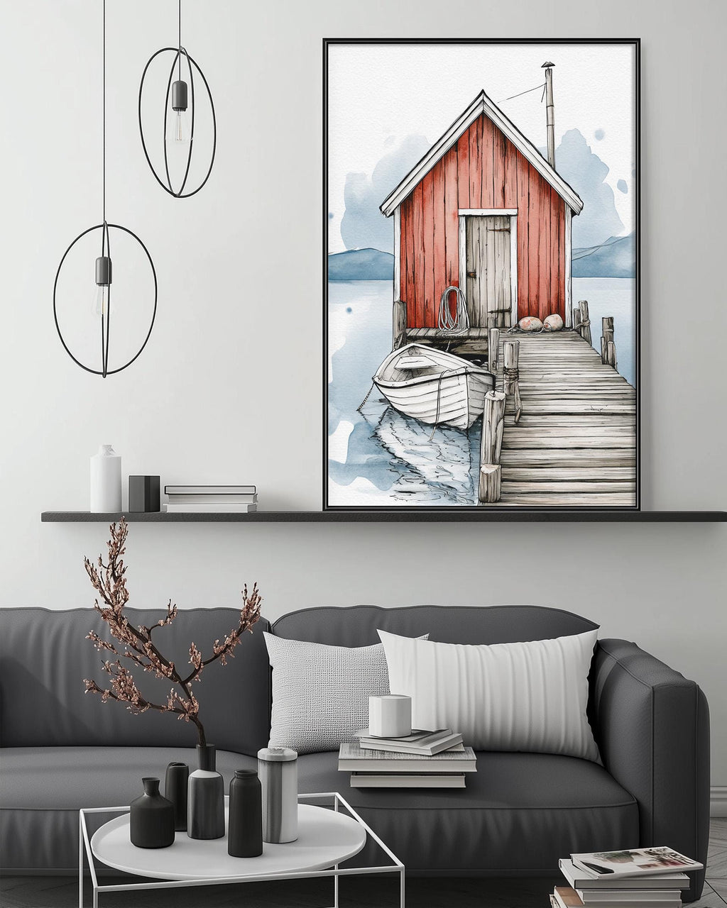 a cozy living room with a gray sofa, a coffee table, and a large framed painting of a red wooden cabin with a dock and boat on the wall above it.