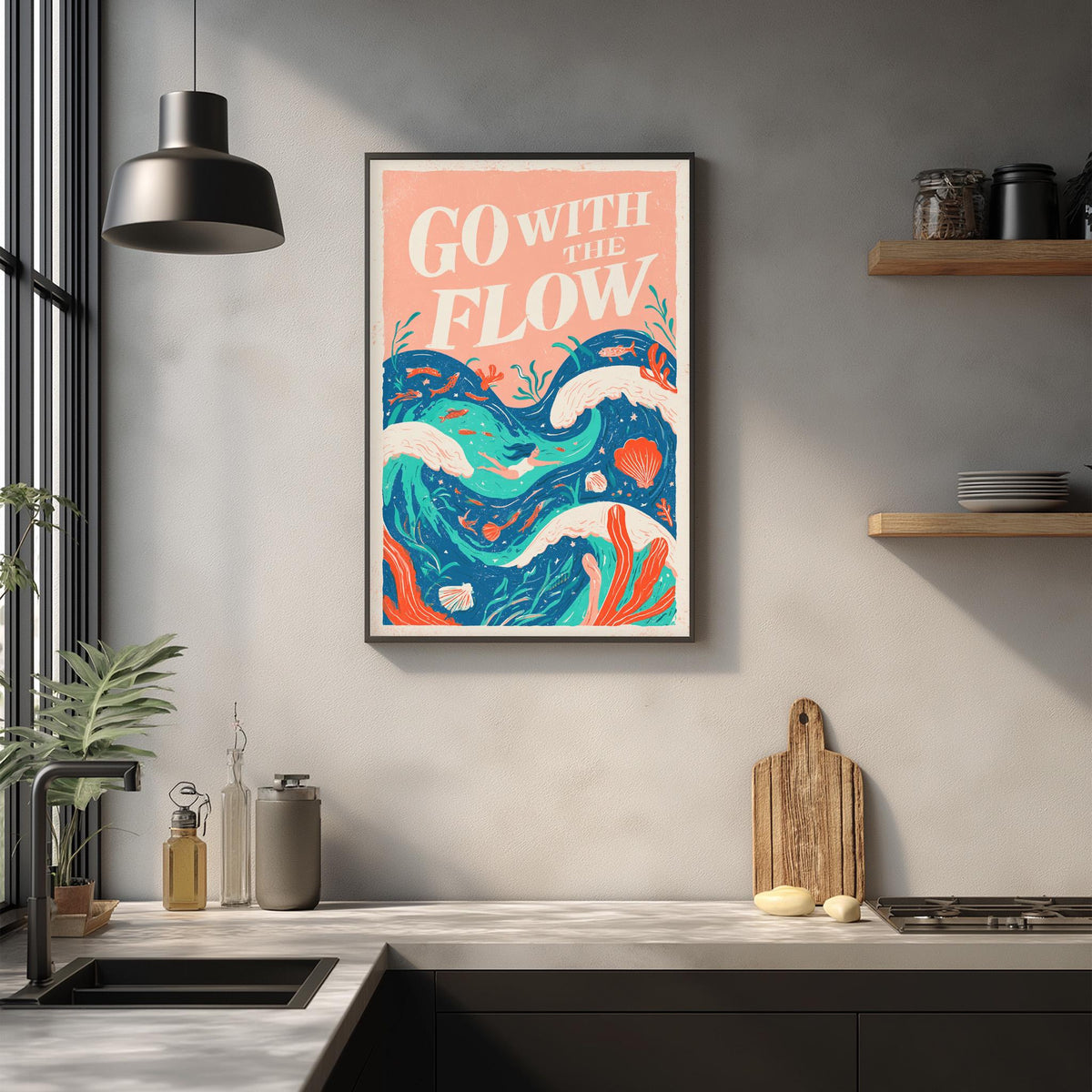 a kitchen counter with a framed poster of a colorful wave design hanging above it. The poster has the text "Go with the flow" written on it.