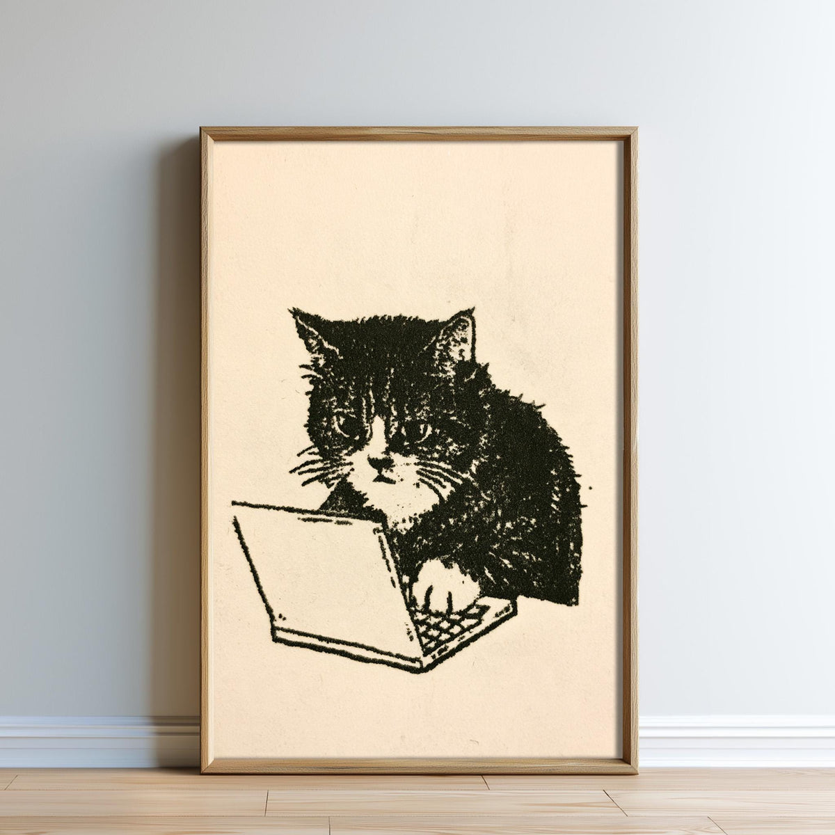 A framed illustration of a cat sitting on a laptop computer.