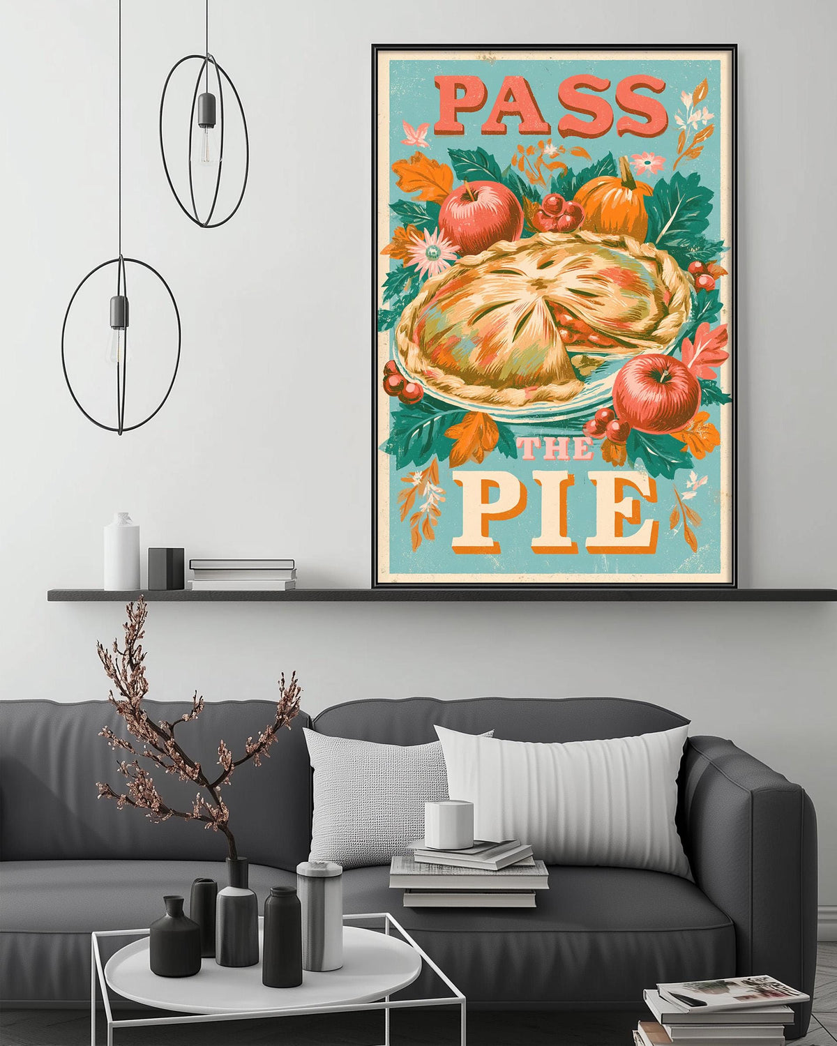 a cozy living room with a gray couch, a coffee table, and a framed poster of a pie on the wall.