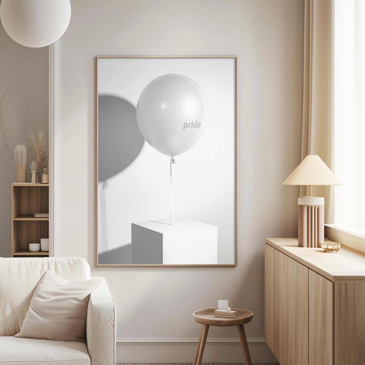 a minimalist living room with a white sofa, a wooden side table, and a framed artwork of a white balloon with the word "pride" on it.
