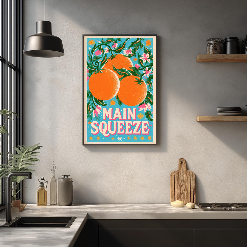 a kitchen counter with a framed poster of oranges hanging on the wall above it.