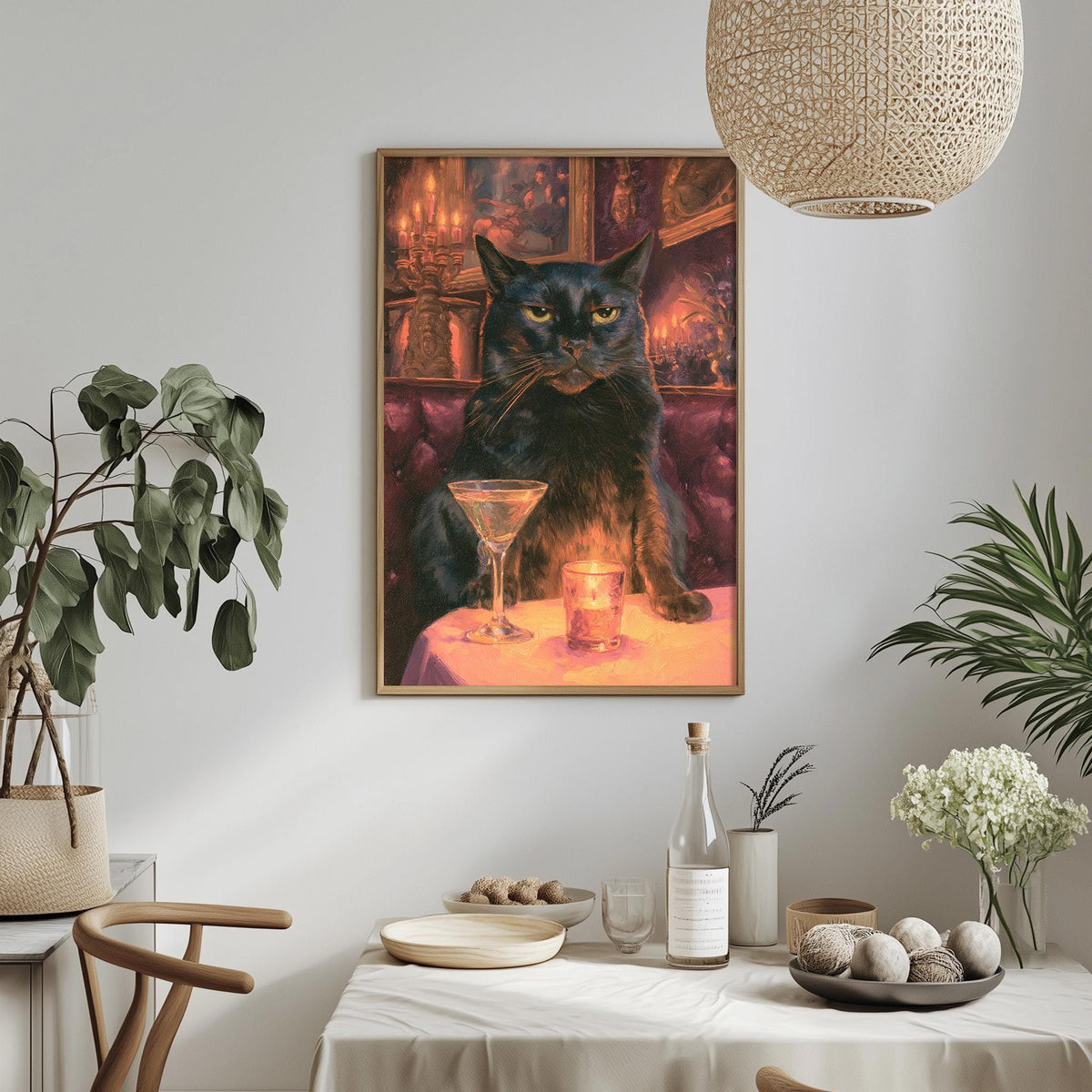 a framed painting of a black cat sitting at a table with a martini glass and a candle, surrounded by various decorative elements such as plants, vases, and bowls.