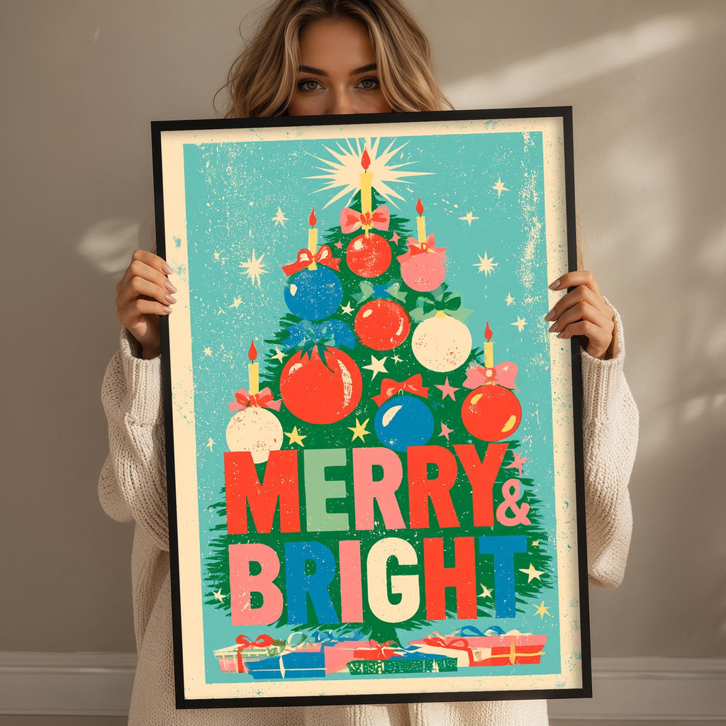 A woman holding a framed poster with a Christmas tree design and the text "MERRY & BRIGHT" on it.