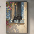 a black cat resting on a window sill, with a framed painting of the cat hanging on the wall above a kitchen counter.