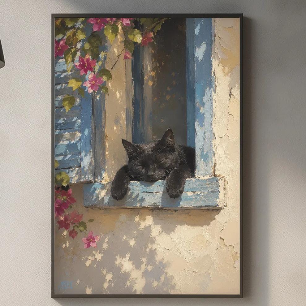 a black cat resting on a window sill, with a framed painting of the cat hanging on the wall above a kitchen counter.