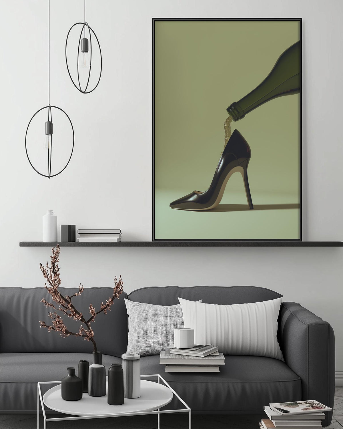 a modern living room with a gray sofa, a coffee table, and a large framed artwork depicting a high-heeled shoe with a bottle of wine pouring out of it.